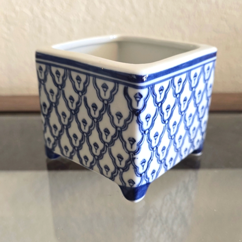 Hand painted Japanese inspired porcelain footed square jar.